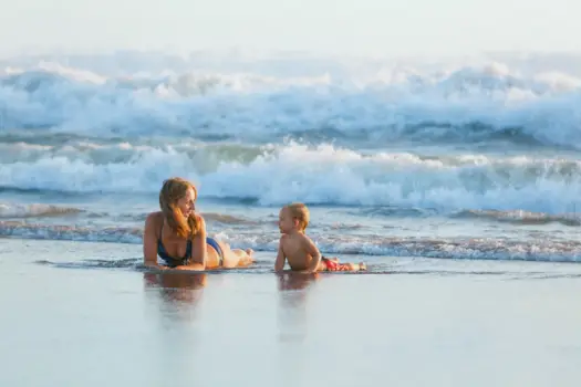 Mum and baby on a beach