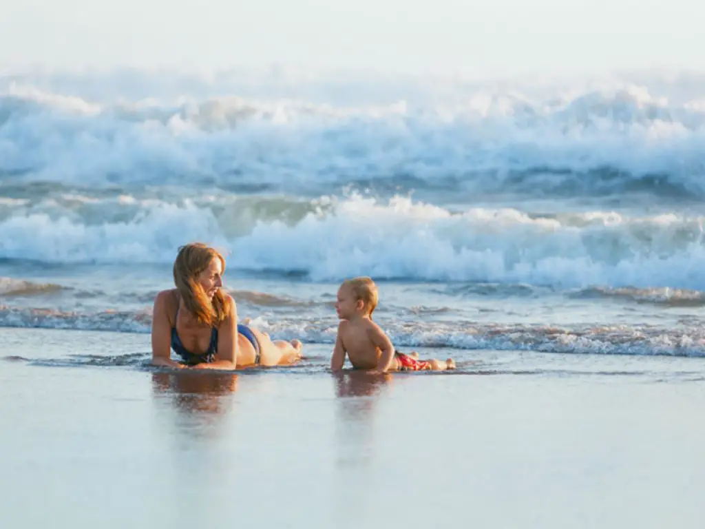 Mum and baby on a beach