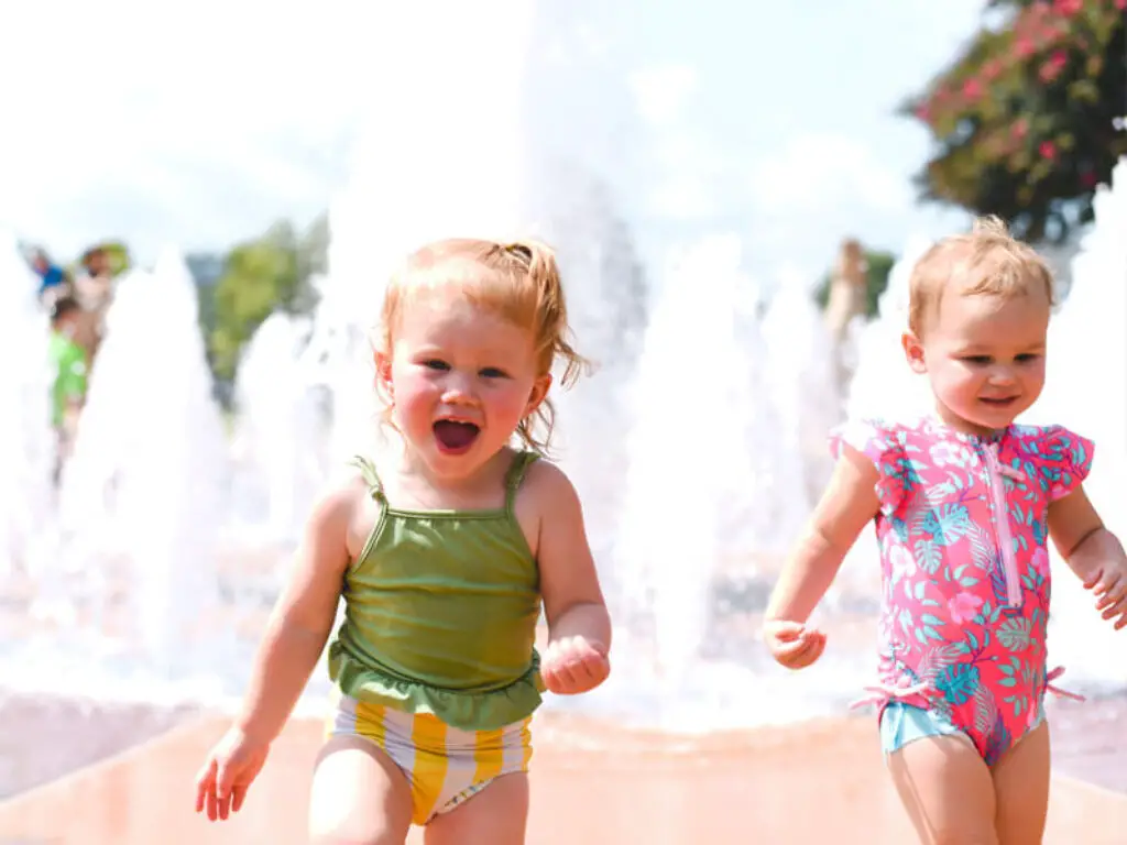 Young kids with water fountain behind